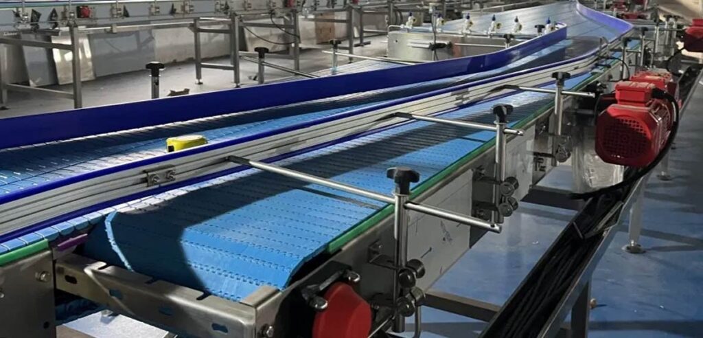 Automotive conveyor system transporting car parts in a manufacturing plant