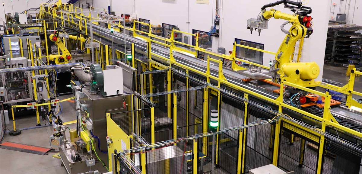 Automotive engine assembly line with robotic workstations in a manufacturing plant Automotive engine assembly line with robotic workstations in a manufacturing plant
